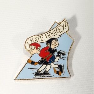 Emblematic Gold Tone Enamel Pin "I hate hockey"